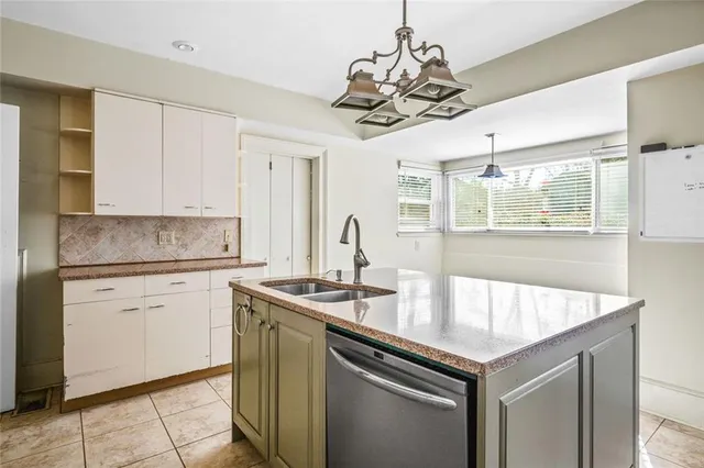 a kitchen with a sink a counter space cabinets and appliances