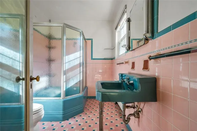 a bathroom with a toilet a mirror and a shower