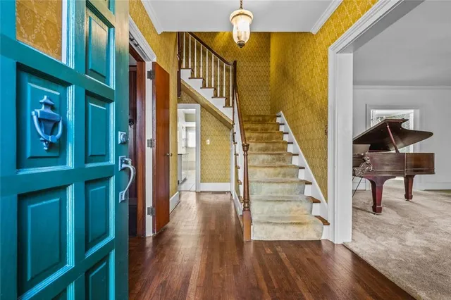 a view of entryway and hall with wooden floor