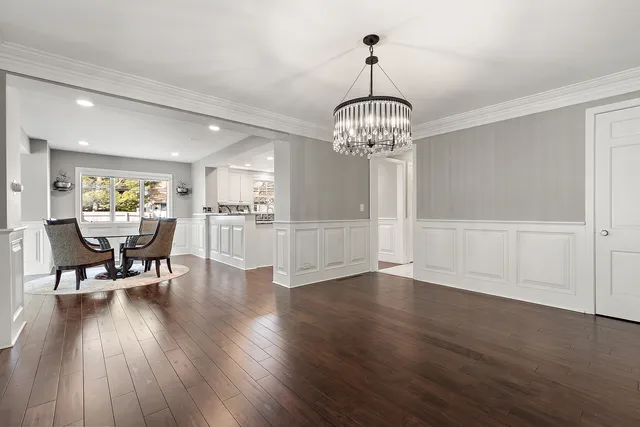 a kitchen with kitchen island white cabinets and stainless steel appliances