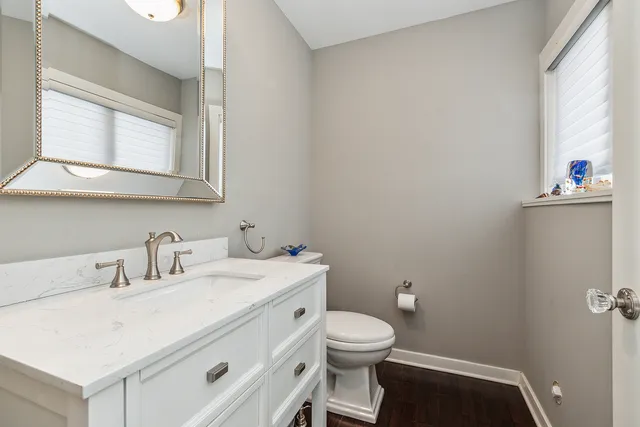 a view of a kitchen with refrigerator and window