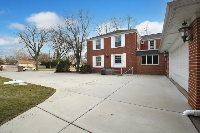 an aerial view of a house with a yard basket ball court and outdoor seating