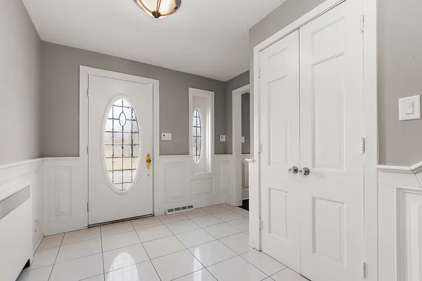 a view of front door with entryway and stairs