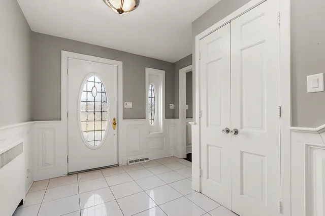 a view of front door with entryway and stairs
