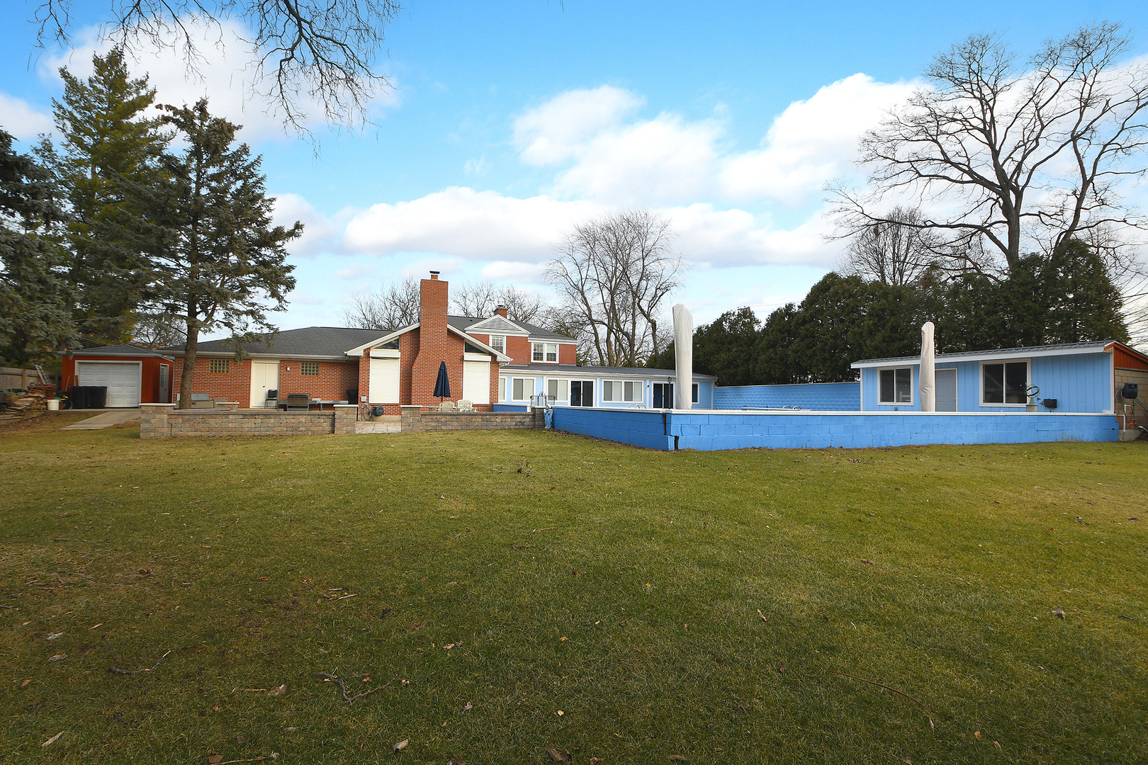 305 North Reed Street Joliet, IL 60435 - Photo 54 of 62 a house view with swimming pool and trees in the background
