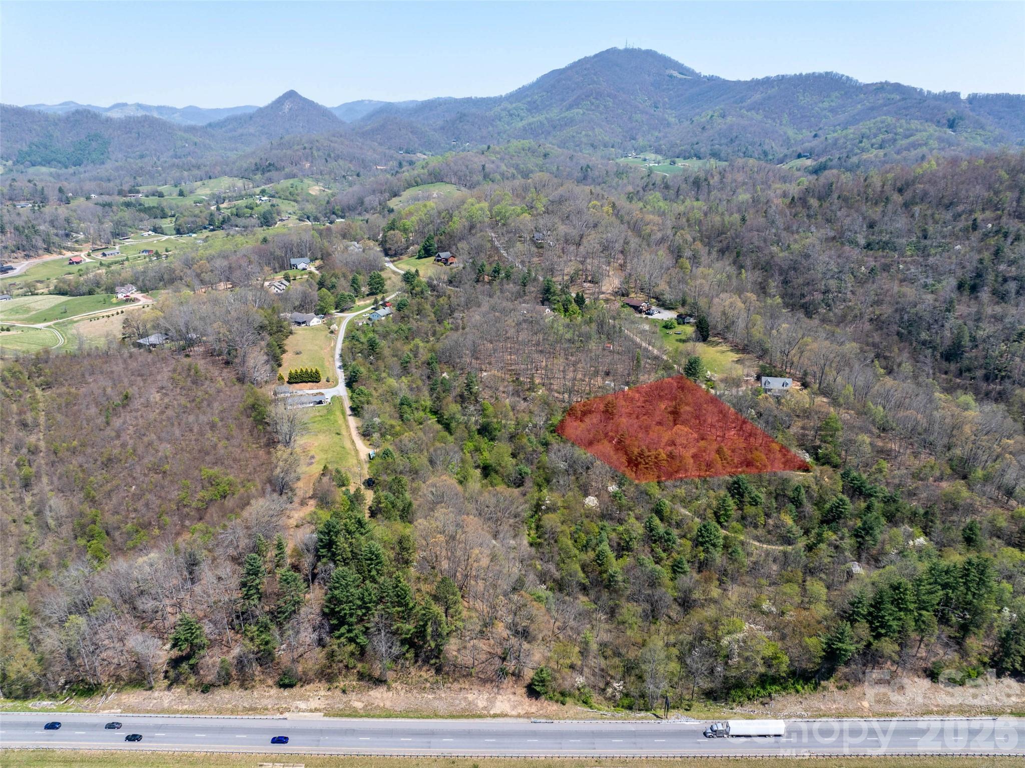 a view of a house with a mountain and a forest