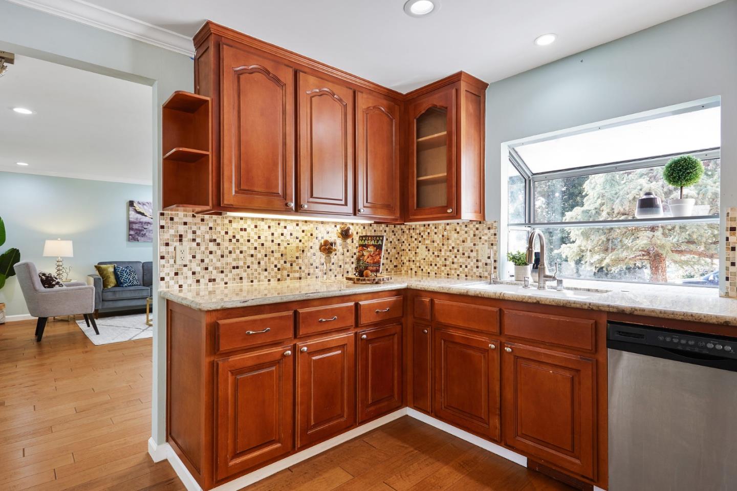 492 Dolores Drive Milpitas, CA 95035 - Photo 14 of 50 a kitchen with stainless steel appliances granite countertop wooden cabinets a sink and dishwasher
