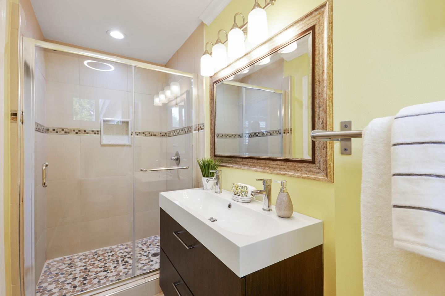 492 Dolores Drive Milpitas, CA 95035 - Photo 34 of 50 a bathroom with a sink a mirror and a shower