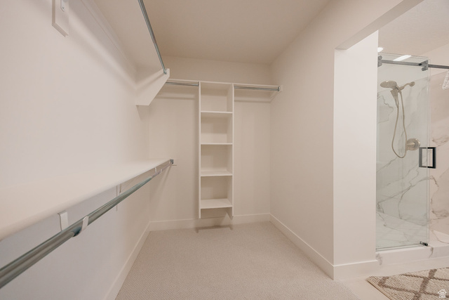5902 Canyon Rim Road, Unit 620 Lehi, UT 84048 - Photo 49 of 78 Walk-in closet featuring white built-in shelving, hanging rods, and light-toned carpeting