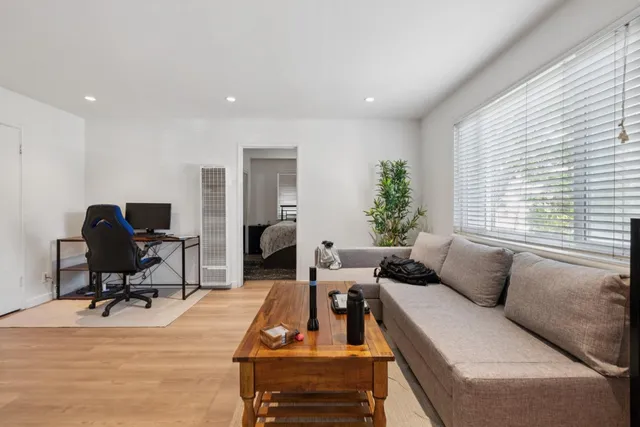 a view of a workspace with furniture and a bedroom