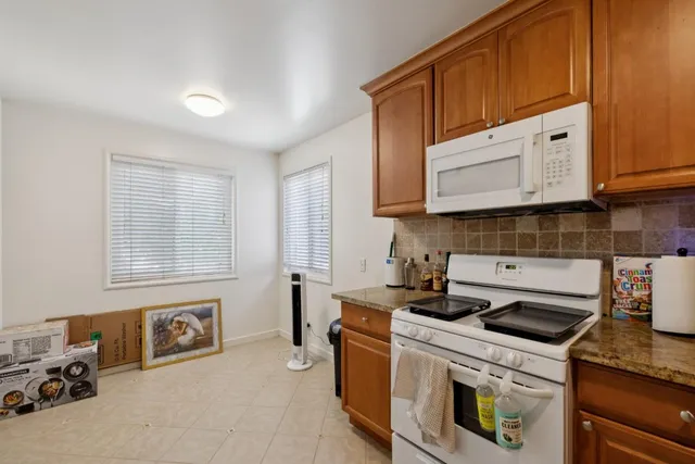 a kitchen with a sink a refrigerator and cabinets