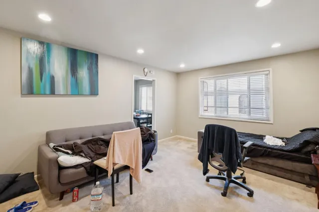 a view of a workspace with furniture and a window