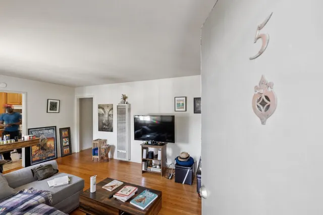 a view of a workspace with furniture and wooden floor