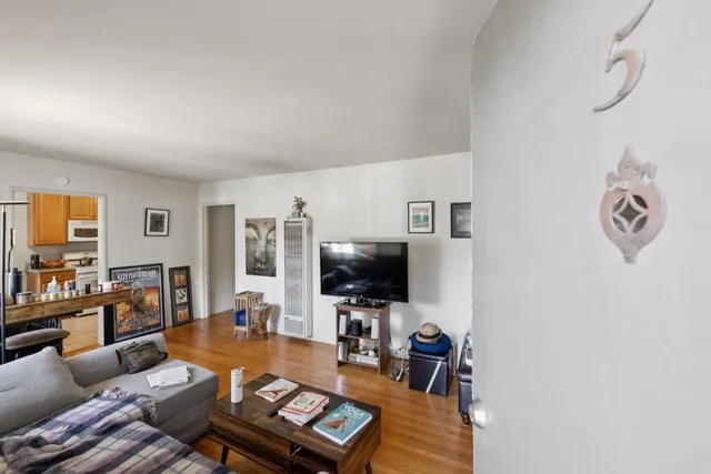 a view of a workspace with furniture and wooden floor