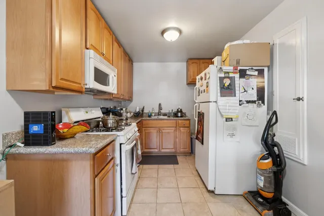 a kitchen with a sink a stove and cabinets