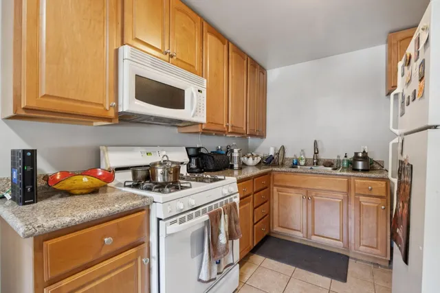 a kitchen that has a lot of cabinets in it and appliances