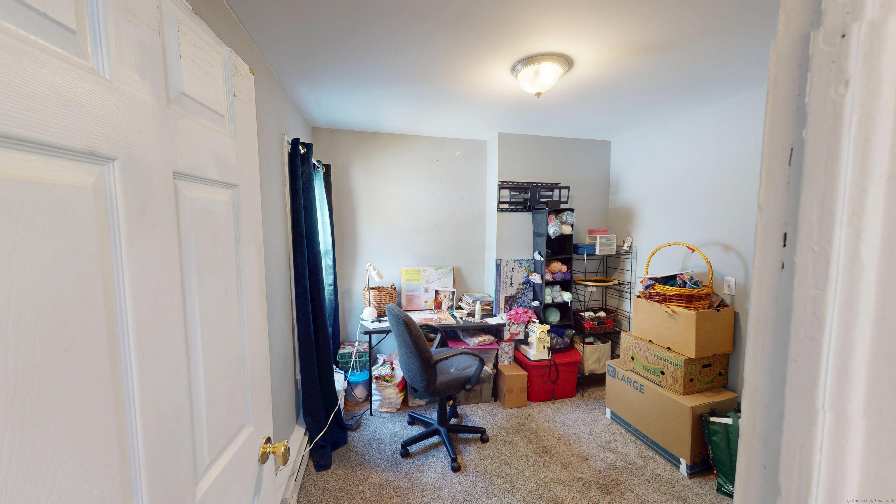 129 Walnut Street Windham, CT 06226 - Photo 8 of 19 1st floor bedroom currently used for a craft / art room and for extra storage.