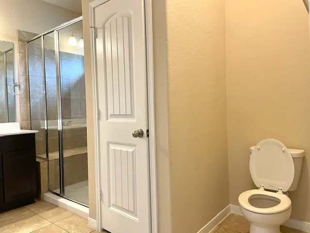a bathroom with a toilet and a shower