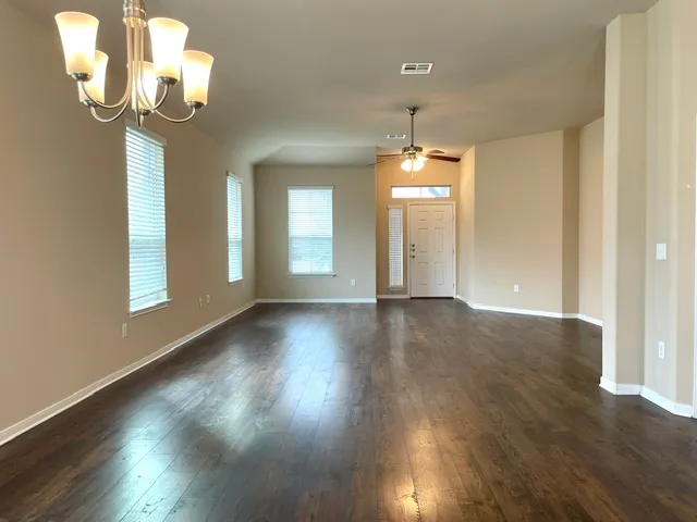 a view of a room with wooden floor