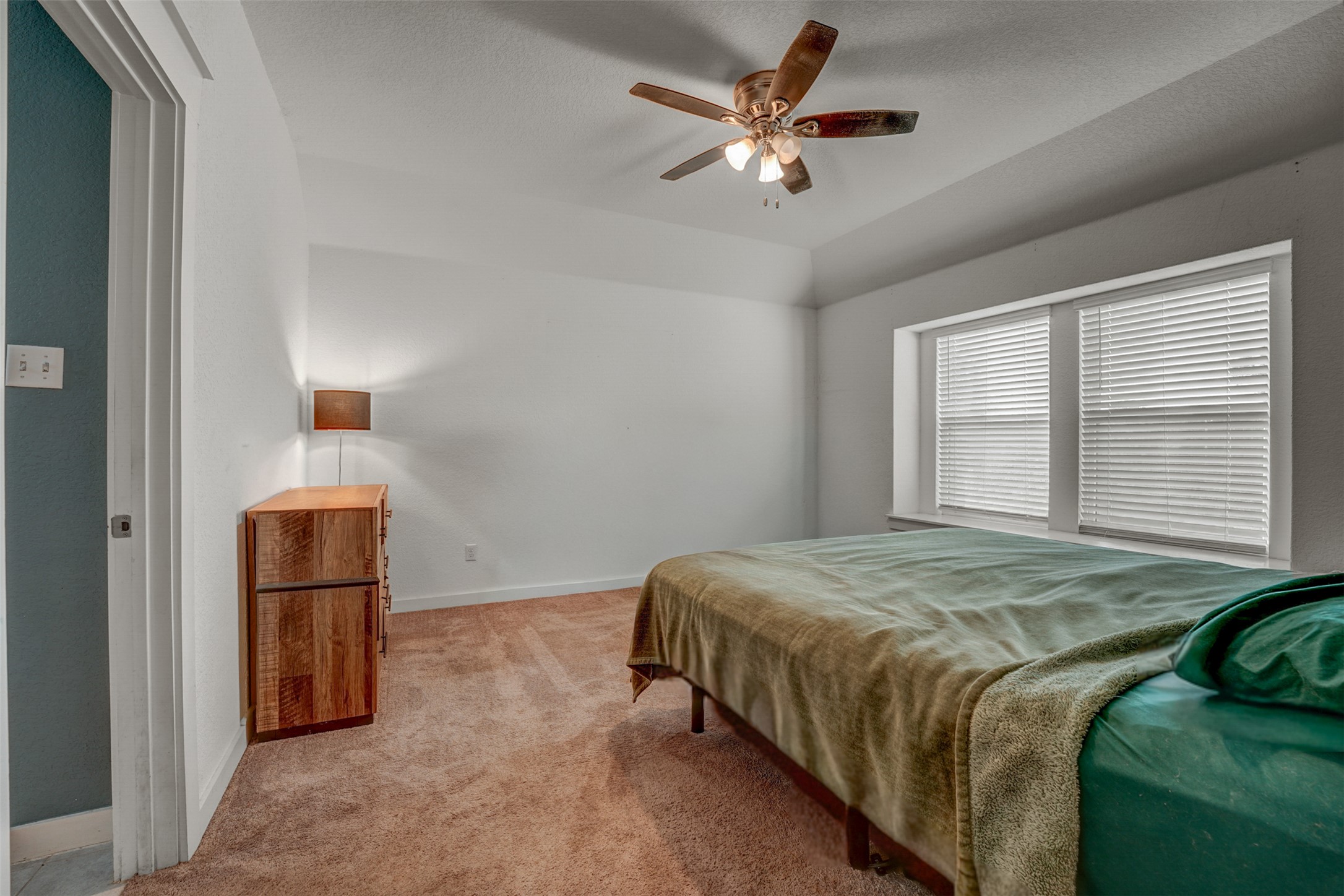 5806 Aviano Road Round Rock, TX 78665 - Photo 21 of 29 Well-lit room provides a peaceful retreat with comfortable carpeting and a ceiling fan.