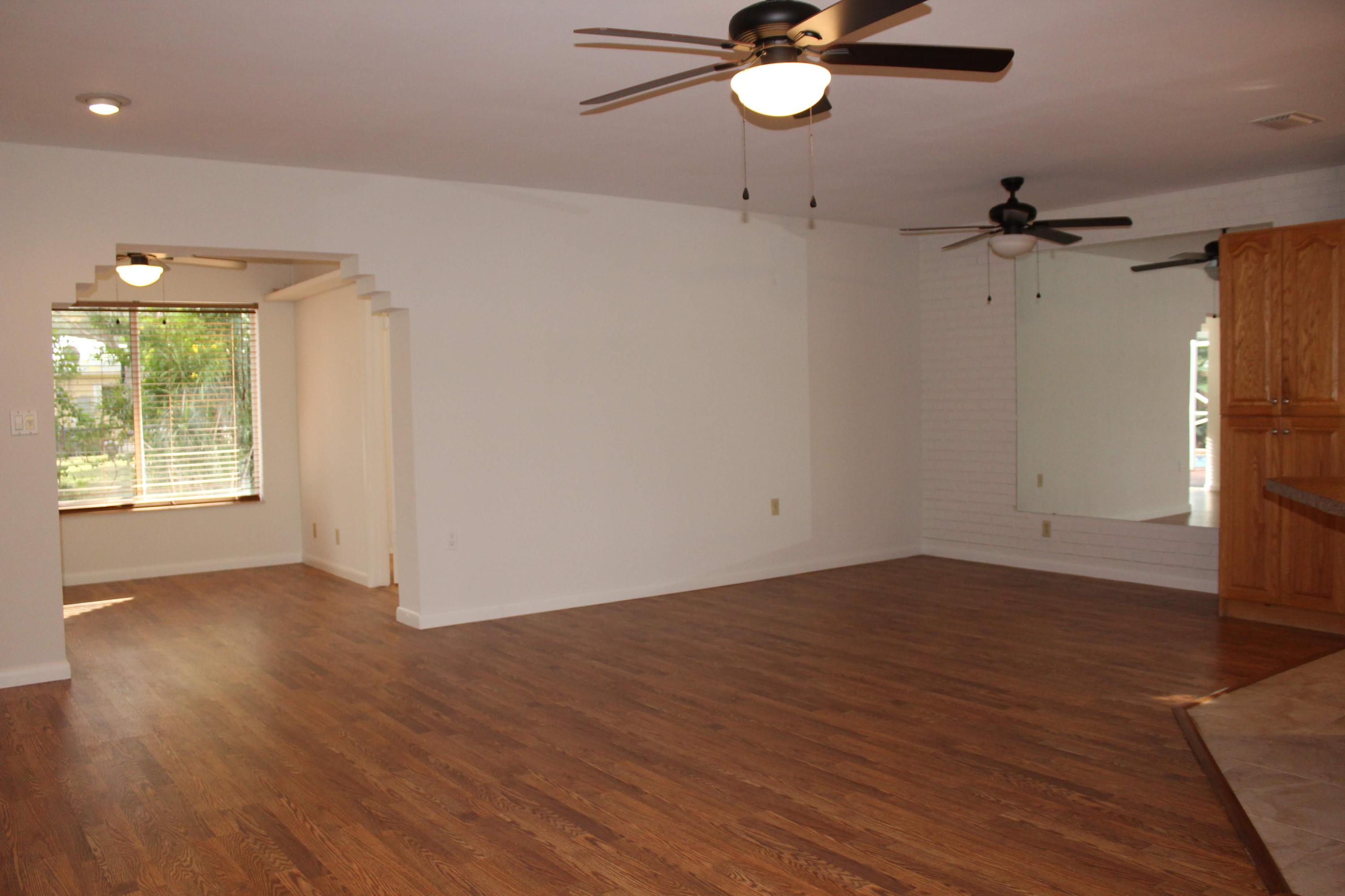 470 Northeast 35th Street Boca Raton, FL 33431 - Photo 8 of 48 an empty room with wooden floor fan and windows