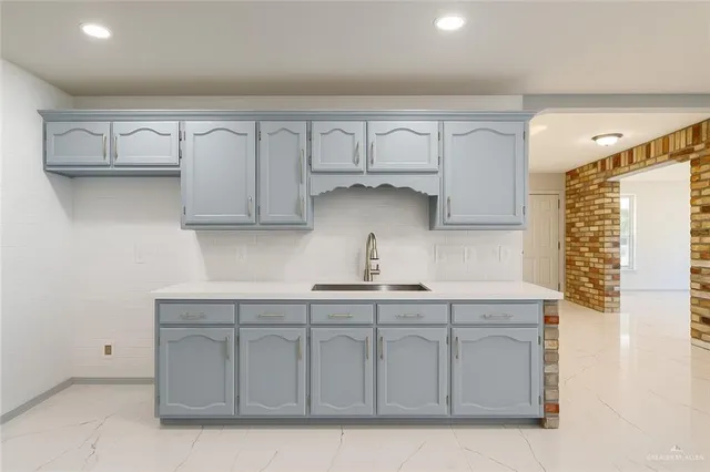 a kitchen with white cabinets