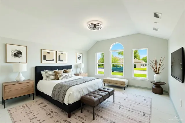 a bedroom with a bed and a flat screen tv