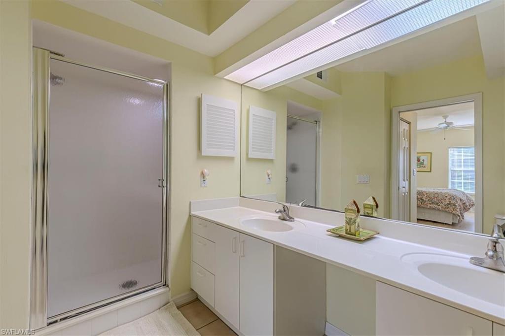 6804 Satinleaf Road South, Unit 102 Naples, FL 34109 - Photo 17 of 35 a bathroom with a sink and a mirror