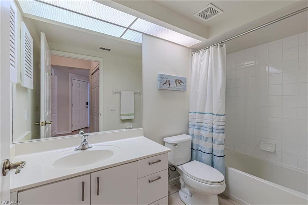 6804 Satinleaf Road South, Unit 102 Naples, FL 34109 - Photo 20 of 35 a bathroom with a sink toilet vanity and shower