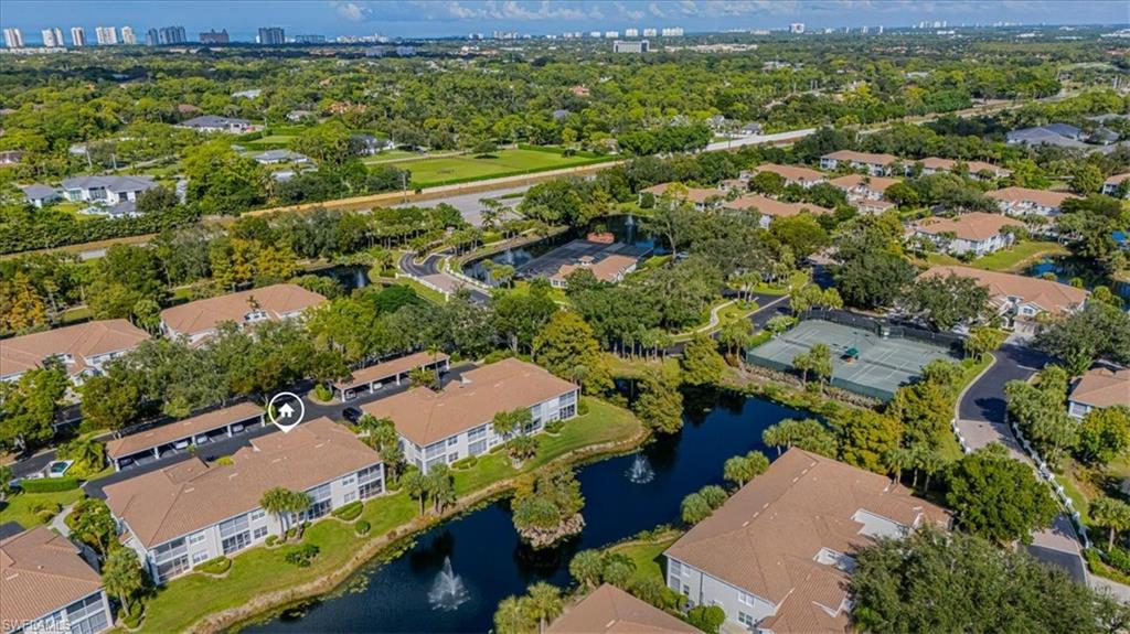 6804 Satinleaf Road South, Unit 102 Naples, FL 34109 - Photo 23 of 35 an aerial view of a houses with a yard