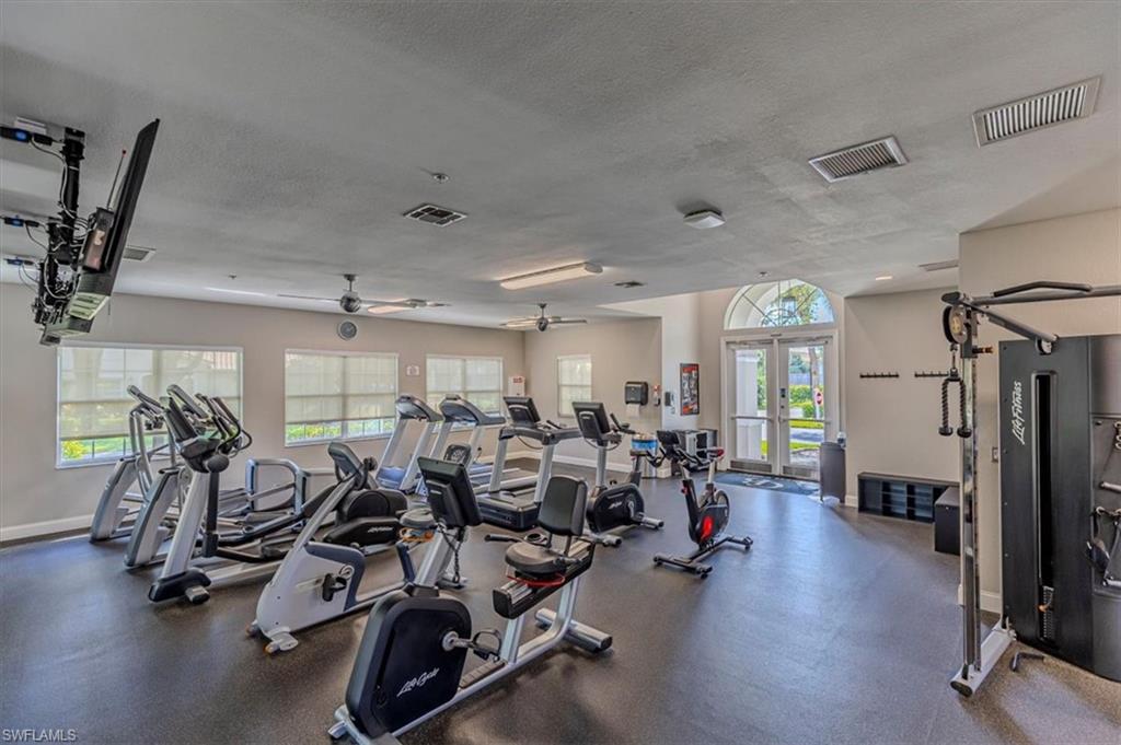 6804 Satinleaf Road South, Unit 102 Naples, FL 34109 - Photo 32 of 35 a room with gym equipment and a large window