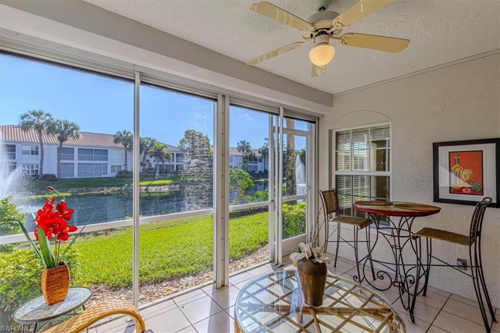 6804 Satinleaf Road South, Unit 102 Naples, FL 34109 - Photo 3 of 35 a view of a livingroom with furniture and a floor to ceiling window