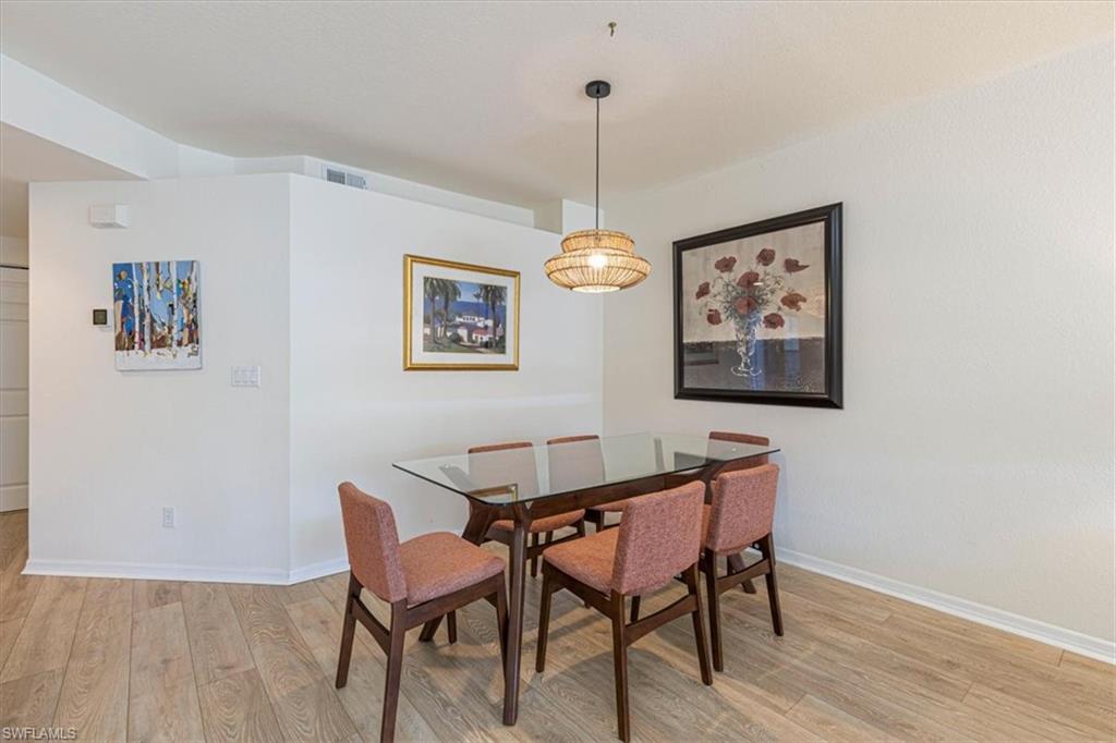 6804 Satinleaf Road South, Unit 102 Naples, FL 34109 - Photo 8 of 35 a dining room with furniture and window