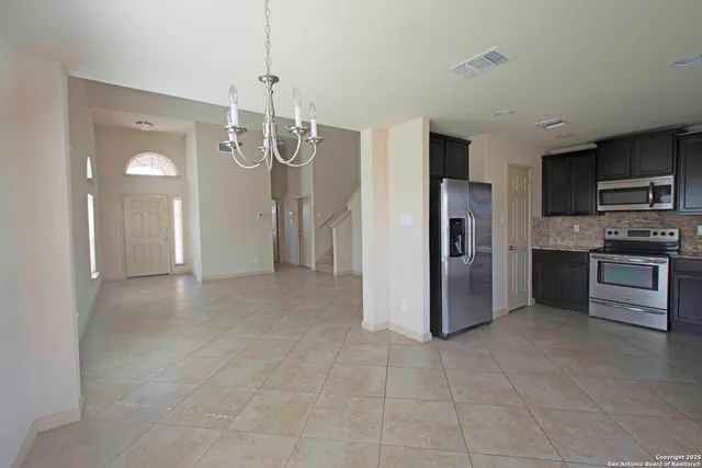 a view of a kitchen with a refrigerator cabinets and a sink