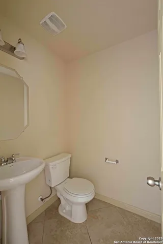 a white toilet sitting next to a bathroom sink