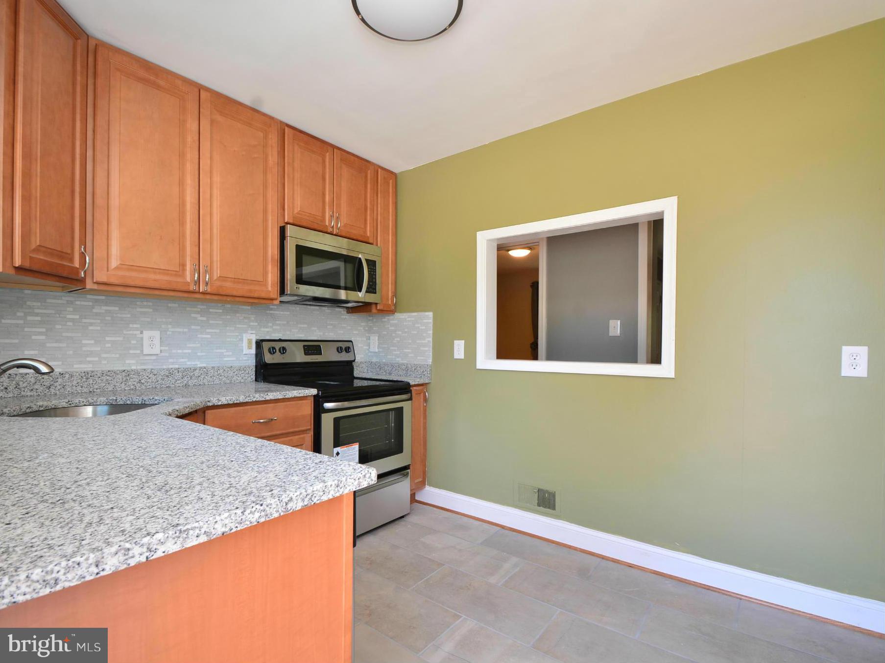1911 Harford Road Fallston, MD 21047 - Photo 8 of 30 a kitchen with granite countertop wooden cabinets and a stove top oven