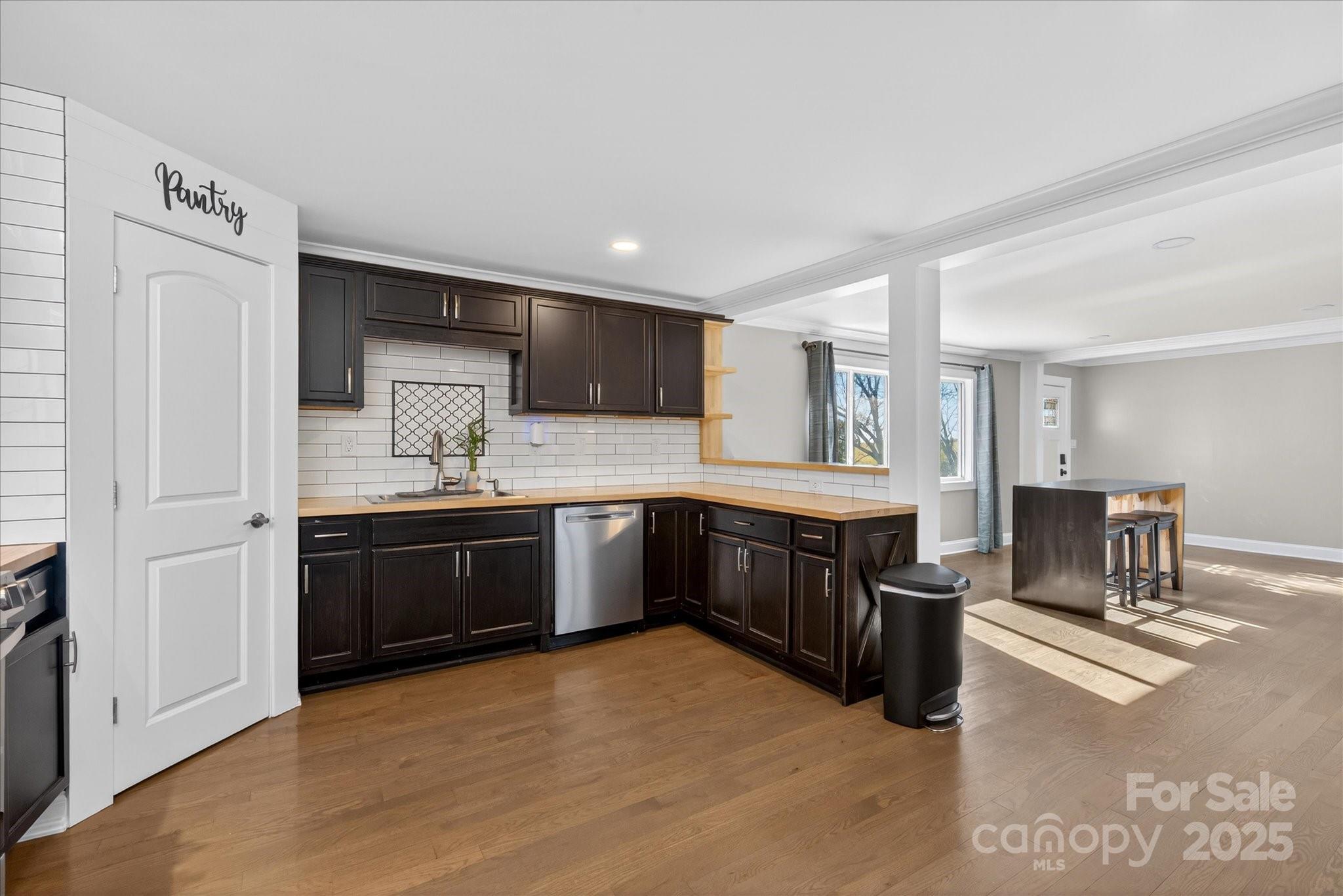 1117 Jug Broome Road Monroe, NC 28112 - Photo 12 of 38 a kitchen with stainless steel appliances kitchen island granite countertop a refrigerator and a stove top oven