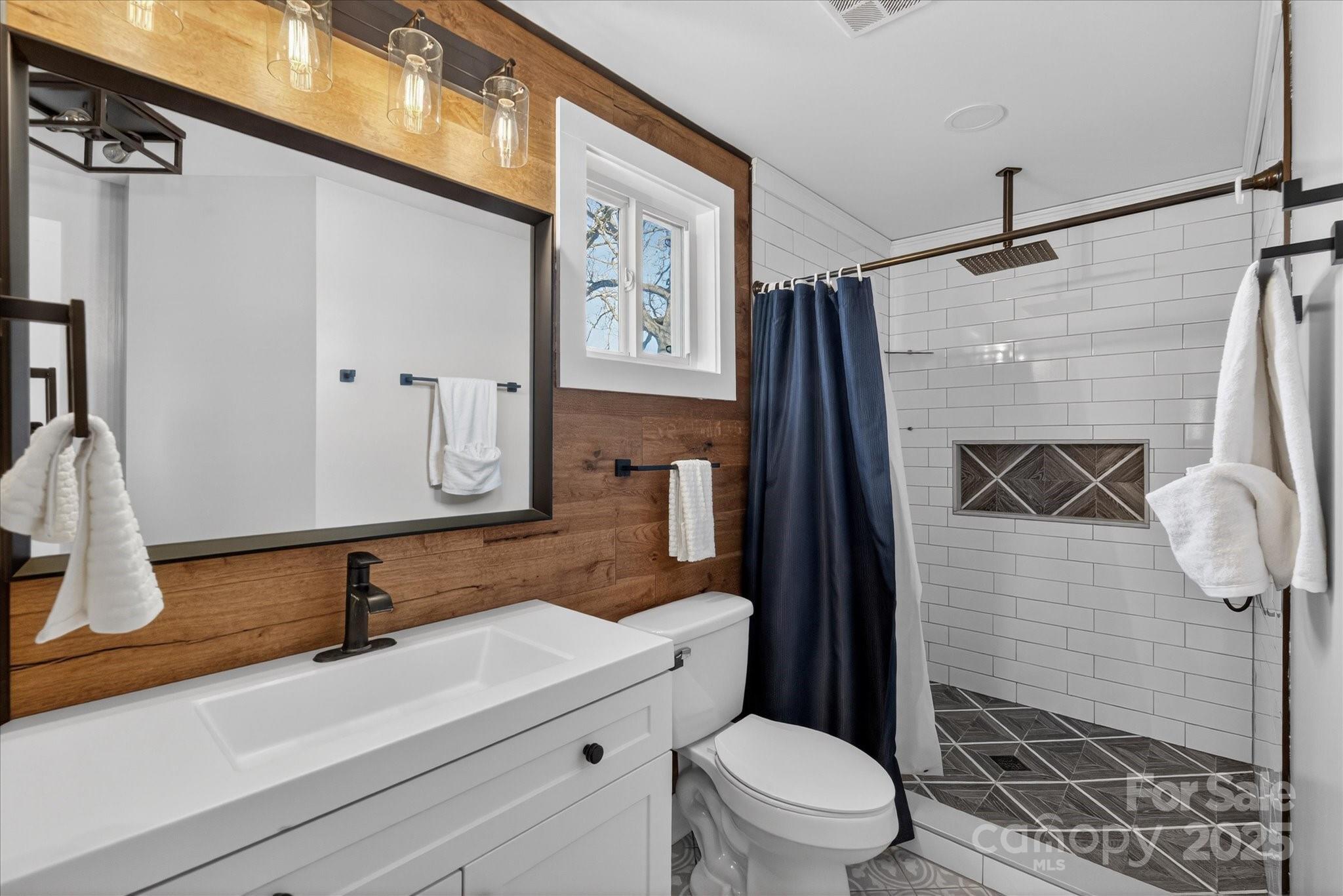 1117 Jug Broome Road Monroe, NC 28112 - Photo 21 of 38 a bathroom with a sink a toilet and shower