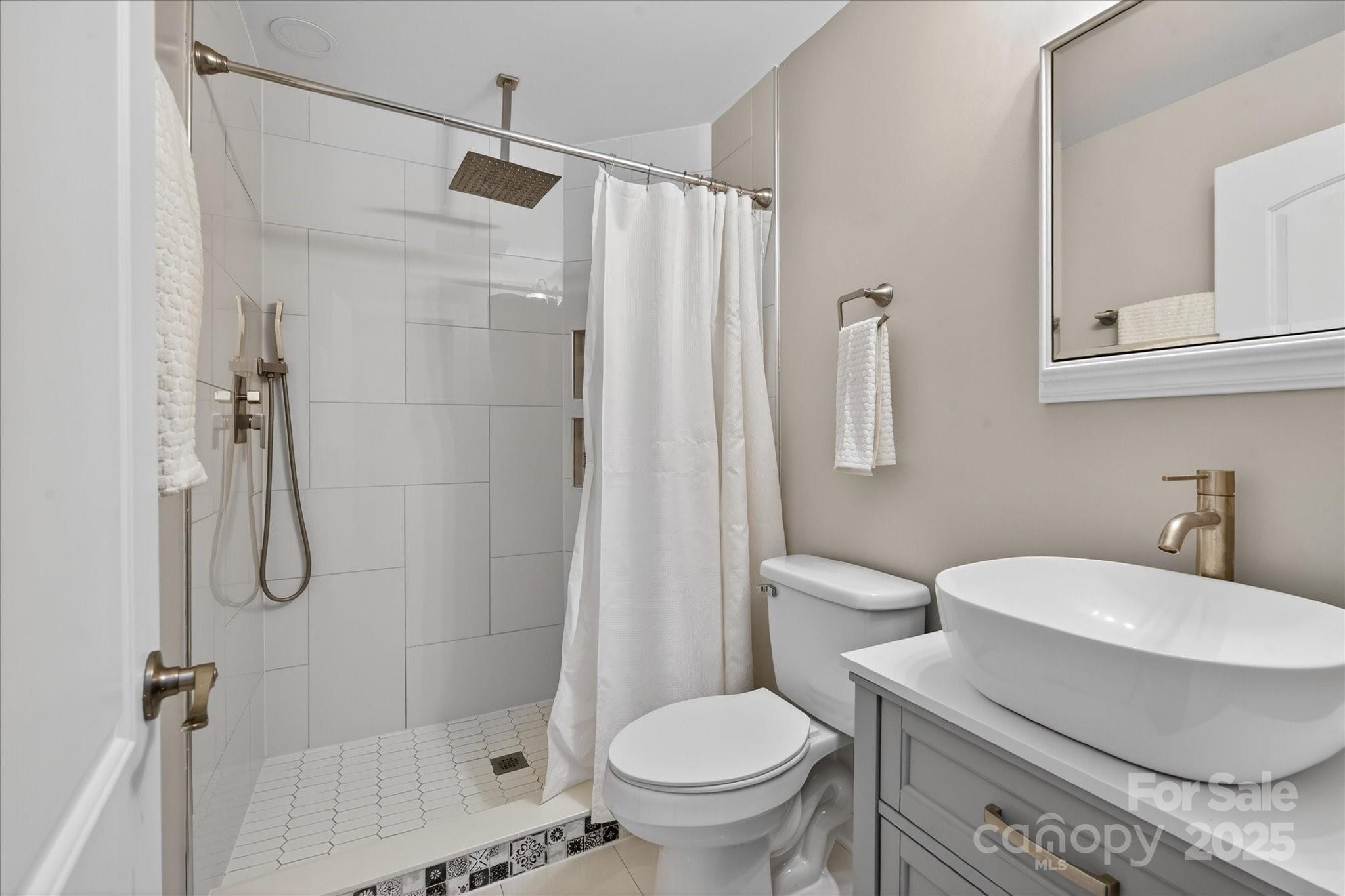 1117 Jug Broome Road Monroe, NC 28112 - Photo 23 of 38 a bathroom with a sink toilet and shower