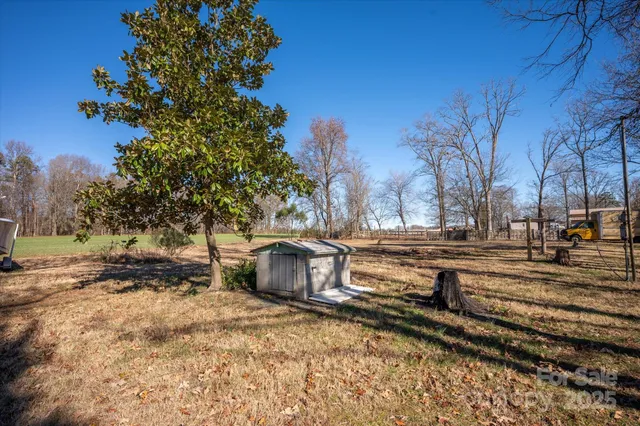 a view of a yard with wooden fence