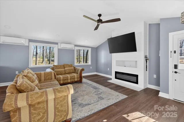 a living room with furniture fireplace and flat screen tv