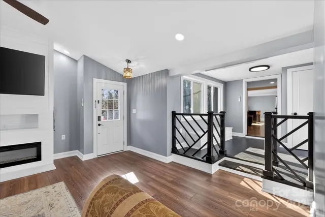 a view of a livingroom with furniture and hardwood floor
