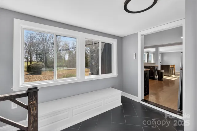 a hallway with a large window and a table