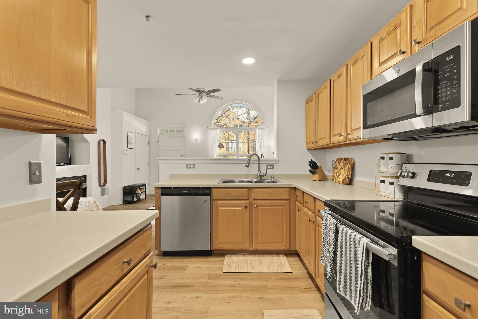 1887 Crescent Park Drive, Unit 111A Reston, VA 20190 - Photo 14 of 27 a kitchen with a sink stove and microwave