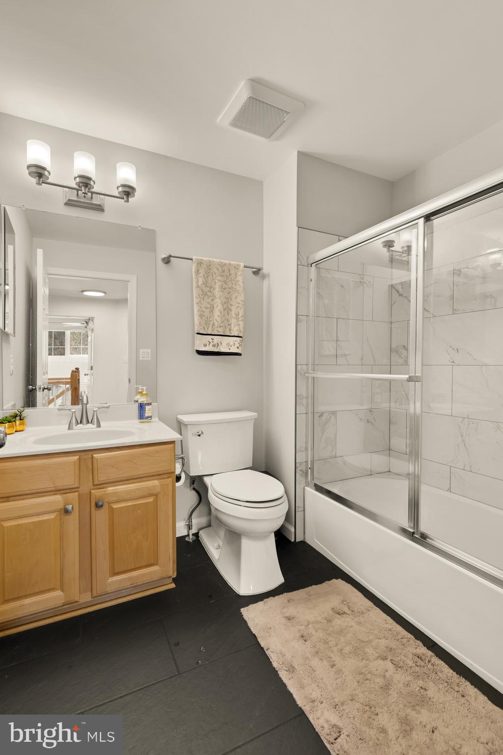1887 Crescent Park Drive, Unit 111A Reston, VA 20190 - Photo 16 of 27 a bathroom with a toilet a sink and a mirror