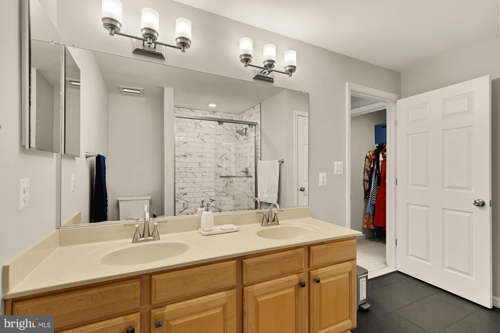 1887 Crescent Park Drive, Unit 111A Reston, VA 20190 - Photo 22 of 27 a bathroom with a double vanity sink and a mirror