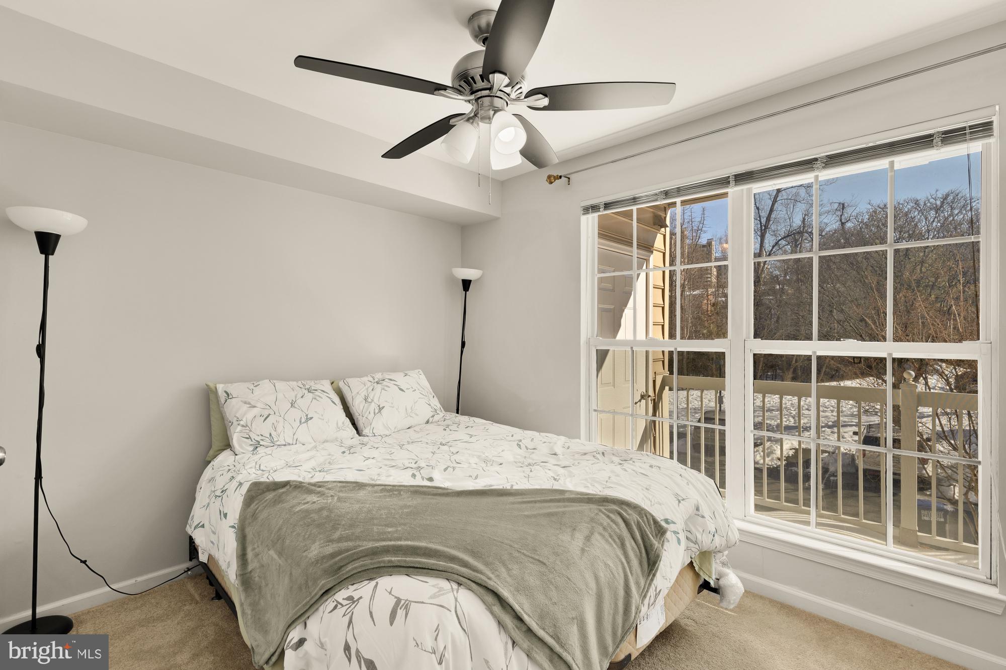 1887 Crescent Park Drive, Unit 111A Reston, VA 20190 - Photo 26 of 27 a bedroom with a large bed and a large window