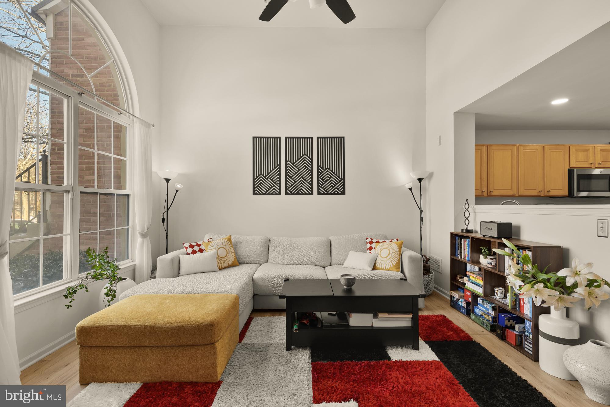 1887 Crescent Park Drive, Unit 111A Reston, VA 20190 - Photo 4 of 27 a living room with furniture and a book shelf