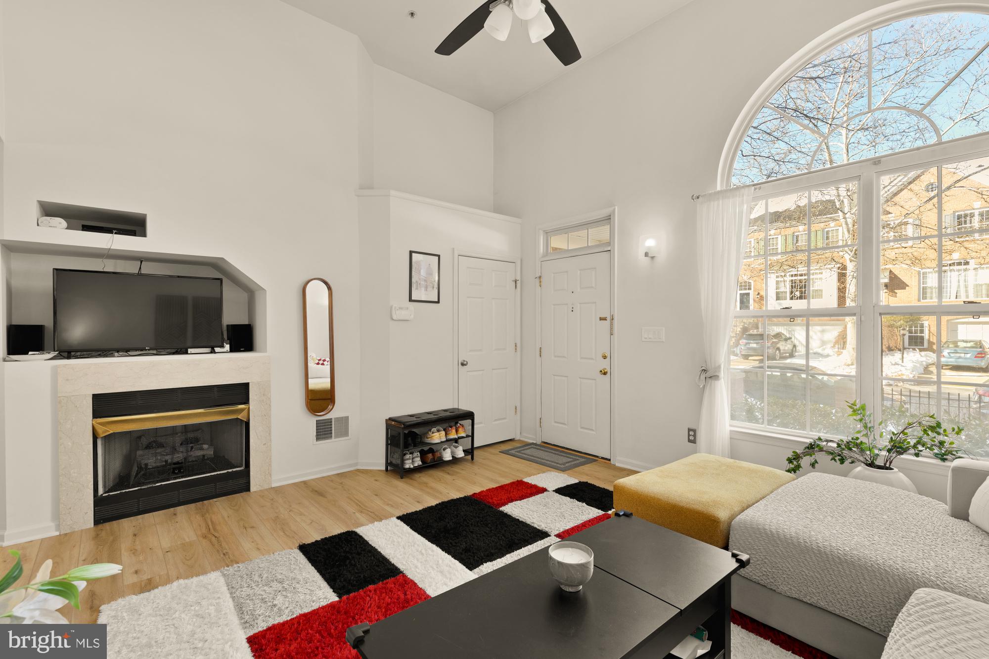 1887 Crescent Park Drive, Unit 111A Reston, VA 20190 - Photo 5 of 27 a living room with furniture fireplace and flat screen tv