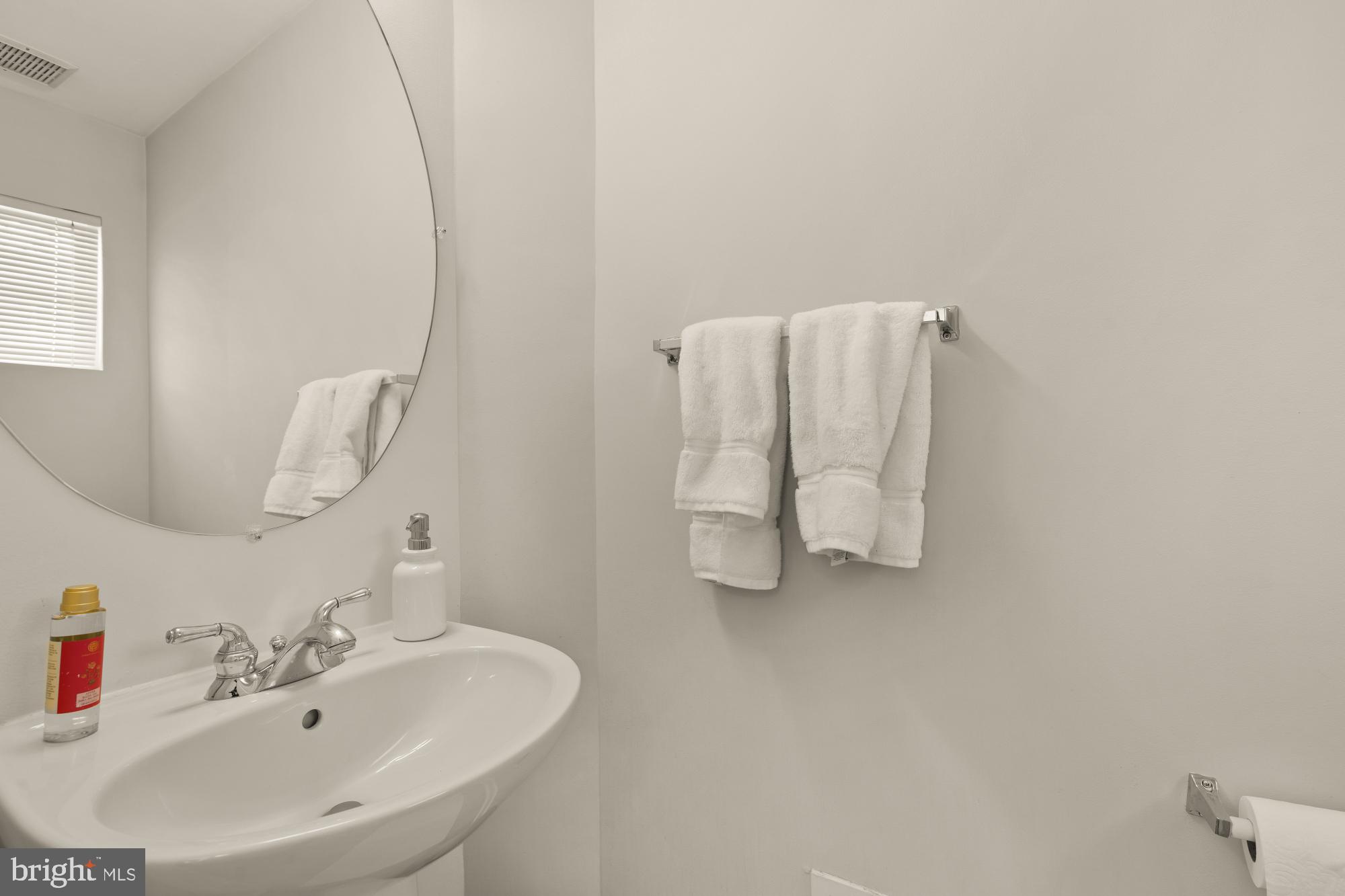 1887 Crescent Park Drive, Unit 111A Reston, VA 20190 - Photo 6 of 27 a bathroom with a sink and mirror